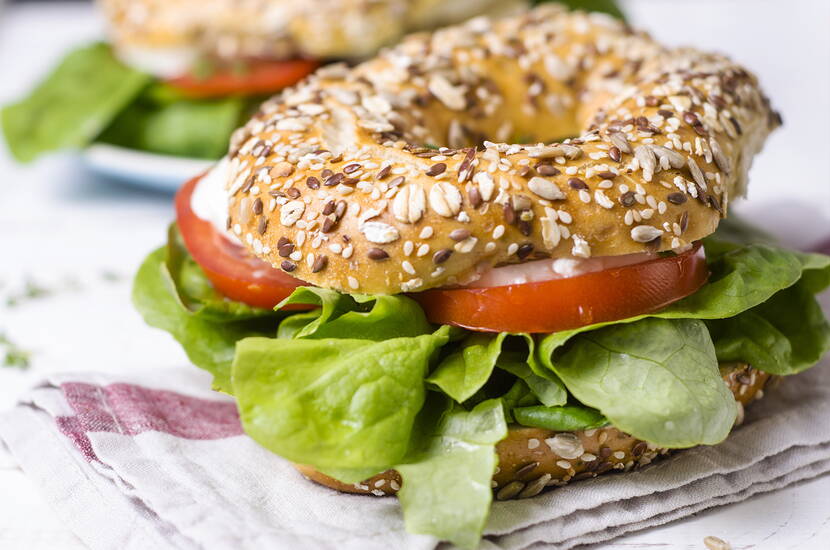 Einen gewöhnlichen Hefeteig (vorzugsweise aus Urdinkel- und Vollkornmehl gemischt) herstellen und aufgehen lassen. Danach den Teig portionenweise zu Kugeln rollen auf ein Backblech legen und mit dem Stiel eines Kochlöffels in die Mitte stechen. Mit kreisrunden Bewegungen das Loch erweitern. Anschliessend die Bagles noch einmal gehen lassen. 